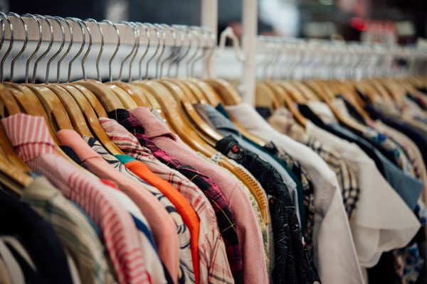 A hanger filled with clothes representing the variety of different products and ways to profit with a clothing brand