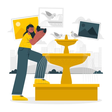 Illustration shows a young person at a park, standing by a fountain. This person is holding a camera and is taking pictures of the birds drinking water from the fountain. This image helps illustrate photography as one of the business ideas for teens on this list.