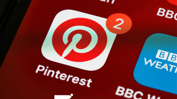 Photo shows phone screen with the Pinterest icon. There are 2 notifications on the Pinterest app. Photo illustrates article on how to make money on Pinterest.